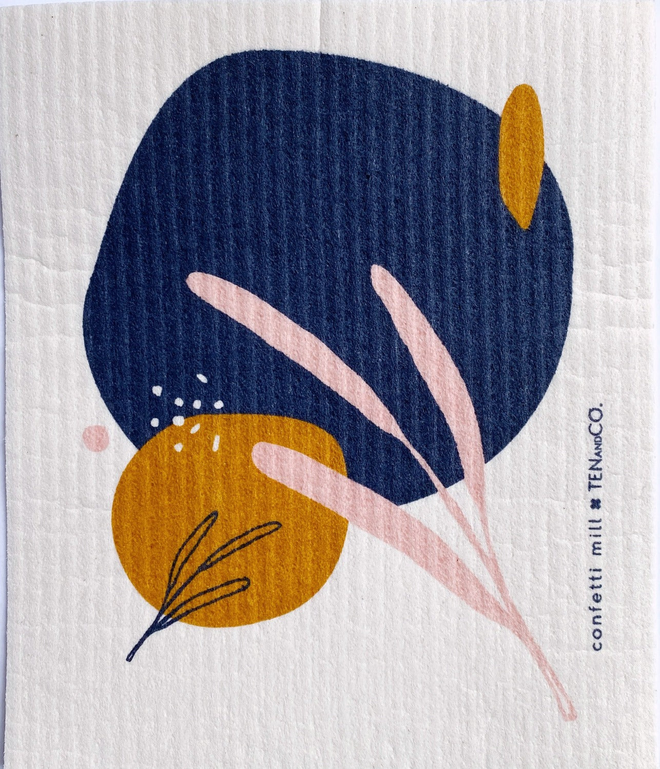 Birds eye view image of 2 of 2 Confetti Mill sponge cloths. The sponge cloth has an abstract floral design in blue, mustard yellow and baby pink.
