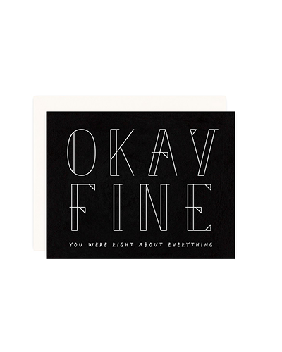 Flat lay image of Okay Fine card on a white background. The card has a black base with “Okay Fine” in large block text in white font. The bottom says “You were right about everything” also in white font.
